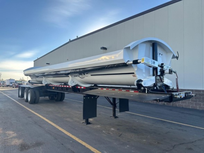 Dump trailer showing Jet Super Spread with folded auger and rear discharge mechanism, 3-axle tandem, storage frame, and hydraulic components.