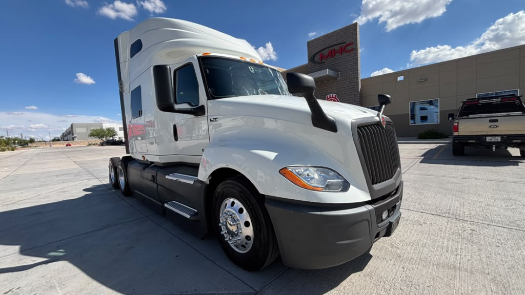 Truck engine bay not visible; exterior front-left view of a white 2022 International LT625 sleeper tractor in a dealership lot.