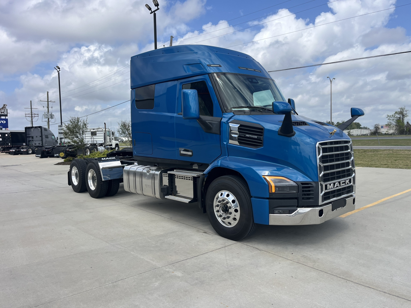 Mack AN64T64 conventional sleeper truck in blue, side view showing cab-forward design and chrome front grille.