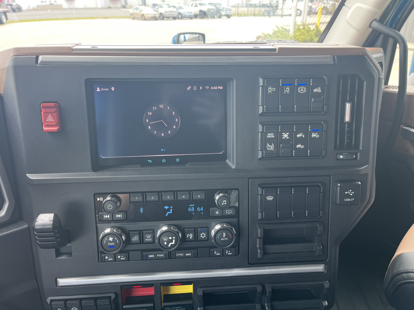 Dashboard of a 2027 Mack AN64T64 truck showing digital gauge display, climate controls, and control switches on the center console.