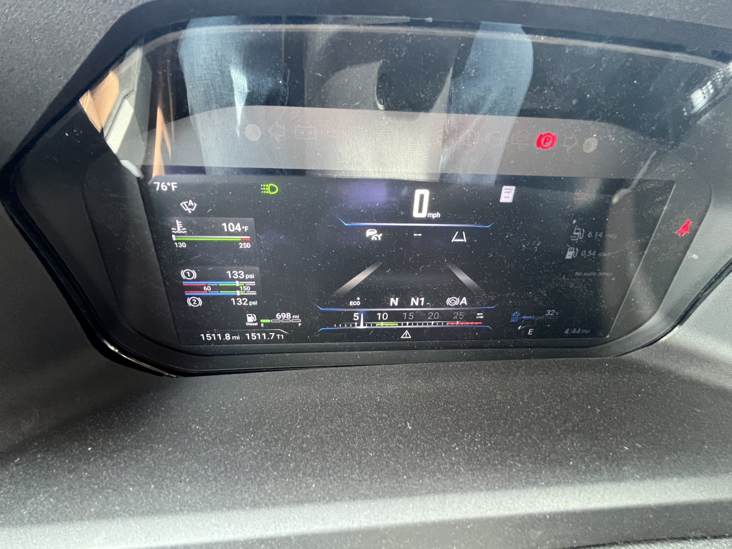 Dashboard display in a 2027 Mack AN64T64 showing digital gauges, speed 0 mph, various indicators and a central screen.
