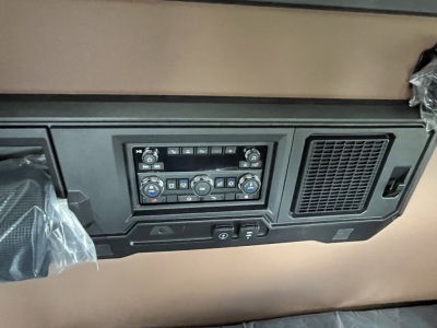 Truck cab dash panel with HVAC controls and vents visible in interior shot.