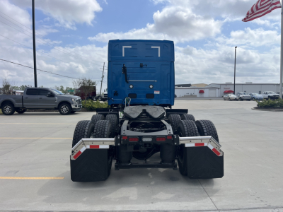 Mack AN64T64 truck tractor rear view showing fifth wheel, dual rear axles, and dual rear tires in a parking lot.