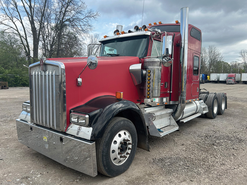 Kenworth W900L AeroCab 1997 conventional sleeper truck in red with chrome exhaust stacks and front bumper.