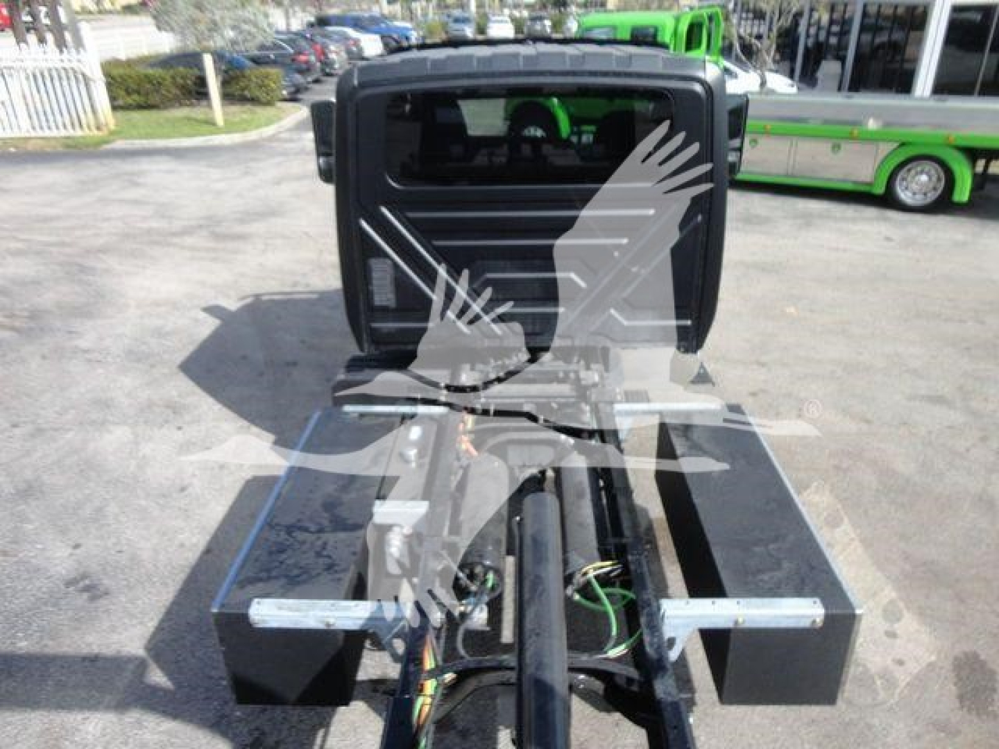 Truck tractor hitch area of a new 2027 International MV rollback unit showing coupling and exposed wiring