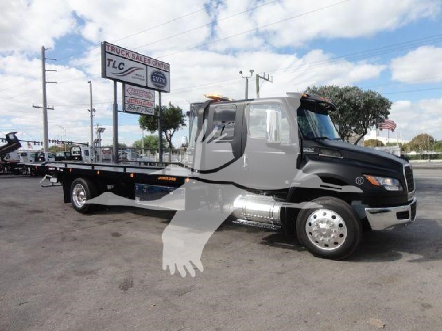 2027 International MV rollback truck showing flatbed and cab details with stock number J47181FM