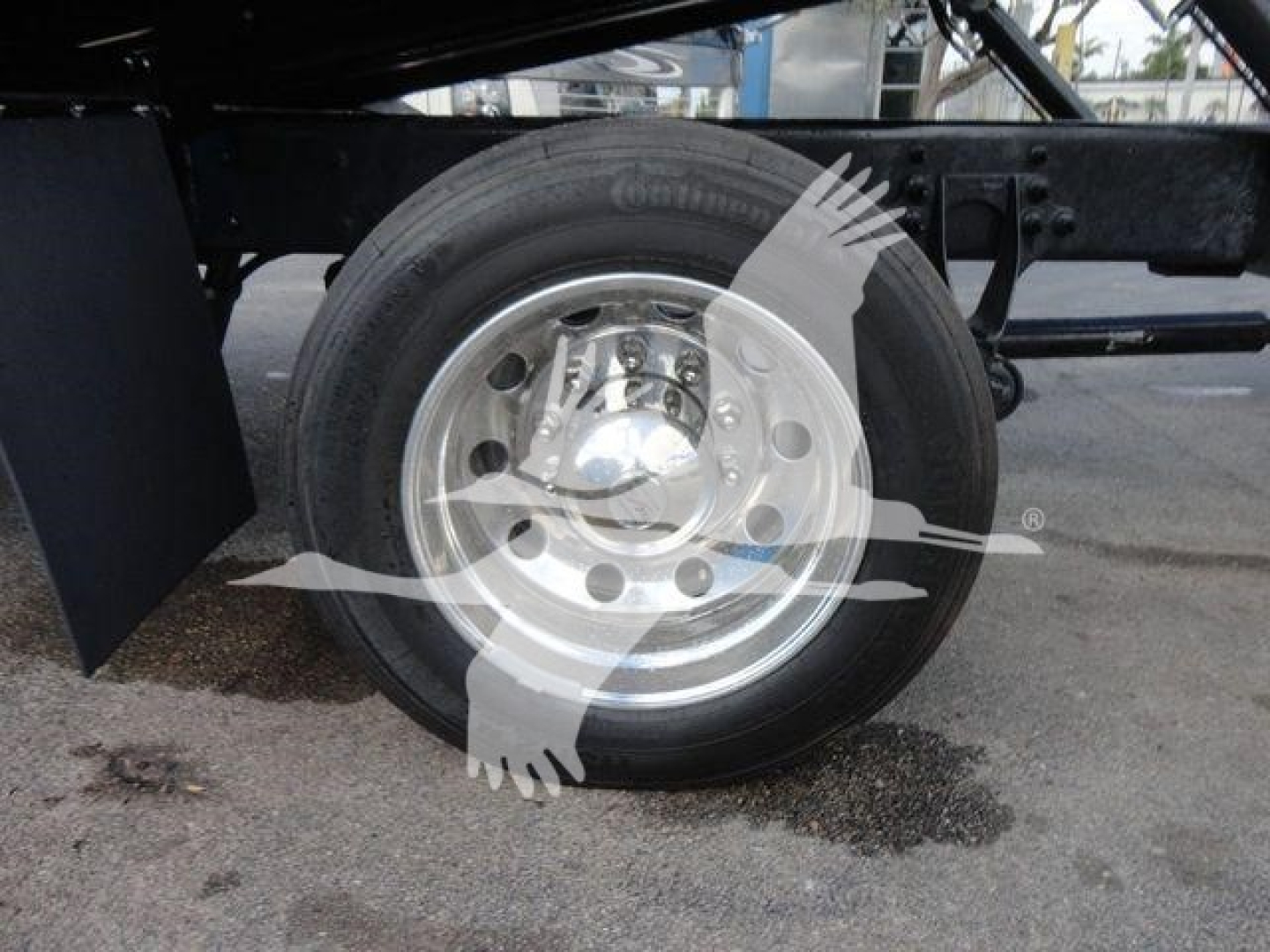 Wheel and suspension of a heavy-duty truck chassis showing a single rear wheel and frame members.