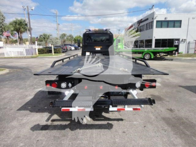 Tow truck bed platform of a 2027 International MV rollback truck seen from rear with hydraulic winch and lights.