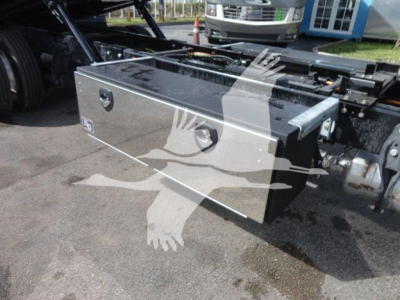 Aluminum toolbox mounted on truck chassis with riveted handles and secure latch, shown from side angle.