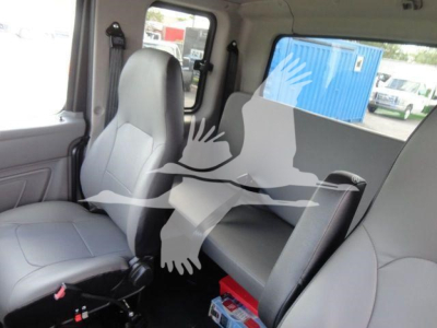 Truck cab interior showing front passenger seat and rear bench seat with window and headrests. No visible labels or text on seats.