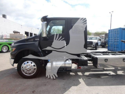 Truck side view showing cab and fuel tanks on International MV rollback truck.