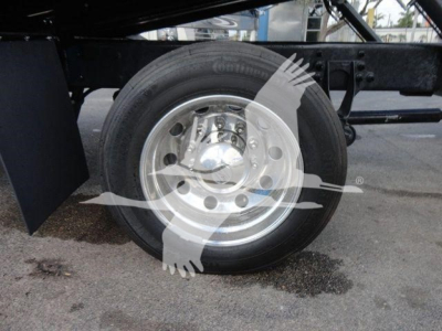Wheel and suspension of a heavy-duty truck chassis showing a single rear wheel and frame members.