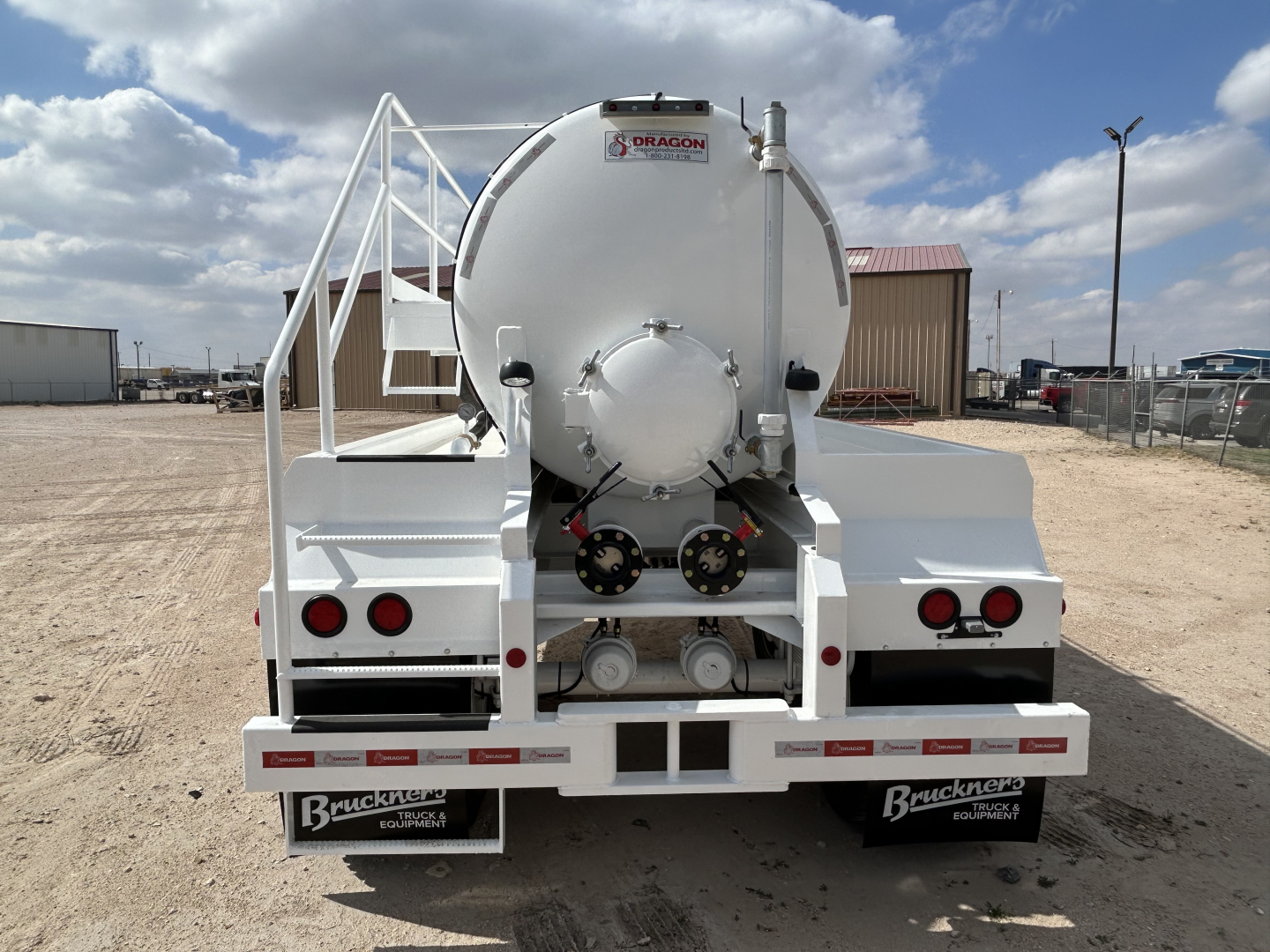 Rear view of 2027 Dragon 130BBL vacuum trailer showing round tank with rear hatch and dual axles.