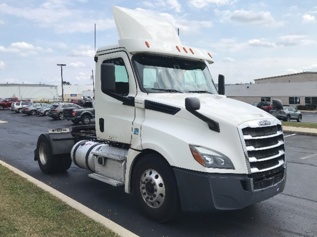 Freightliner Cascadia126 tractor truck in white, side view showing cab and front grille with raised hood, daycab configuration, no trailer attached.