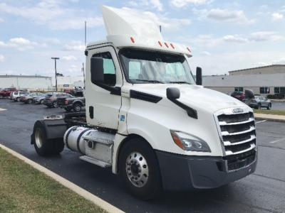 Freightliner Cascadia126 tractor truck in white, side view showing cab and front grille with raised hood, daycab configuration, no trailer attached.