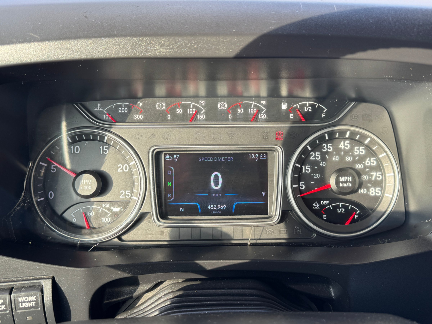 Dashboard of a 2021 International Lonestar truck showing instrument cluster, digital display, and gauges with mph, rpm, fuel, and coolant temp.