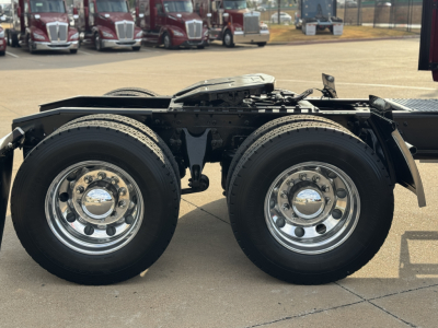 Truck dual rear axles with chrome wheels and suspension, part of the International Lonestar chassis.