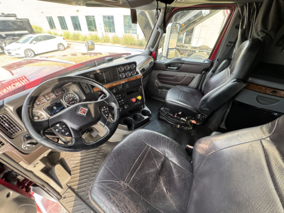 Interior of a truck cabin showing steering wheel, dashboard, and driver seat of a 2021 International Lonestar.