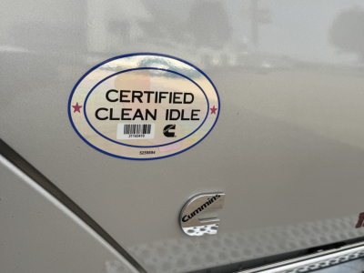 Truck exterior with Certified Clean Idle sticker and Cummins badge on the side.