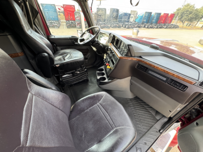Truck cab interior of a 2021 International Lonestar showing steering wheel, dashboard, seats, and center console