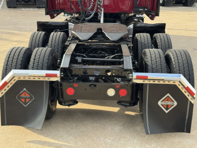 Rear view of a 2021 International Lonestar truck showing dual rear wheels, fifth wheel area, and mud flaps with International diamond logos.