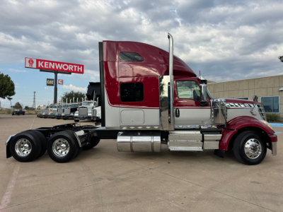 International Lonestar truck side view showing red cab and chrome fuel tanks with dual rear axles.