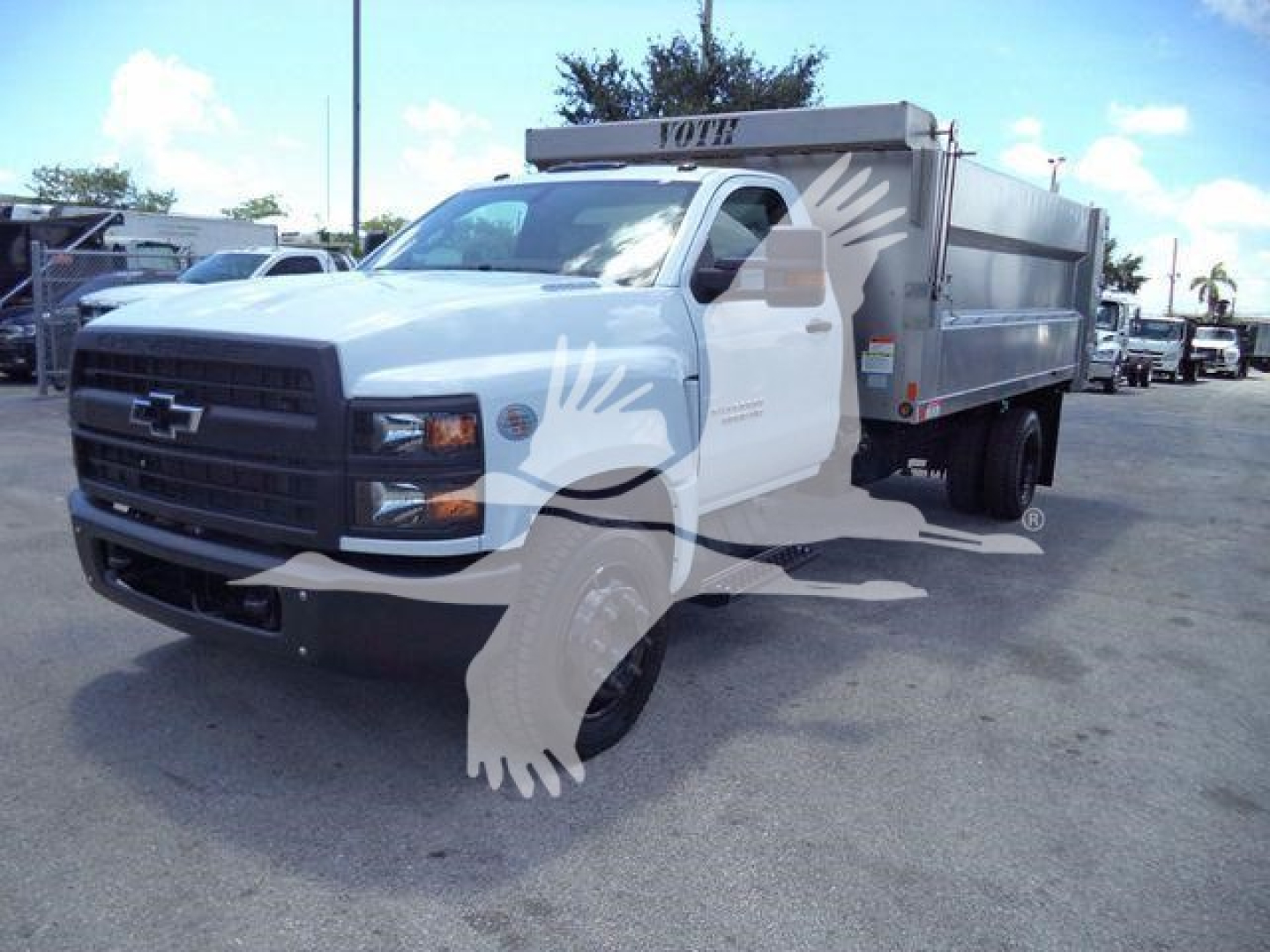 Chevrolet Silverado 6500HD dump truck front-left view showing aluminum dump body and lettering, in service yard.