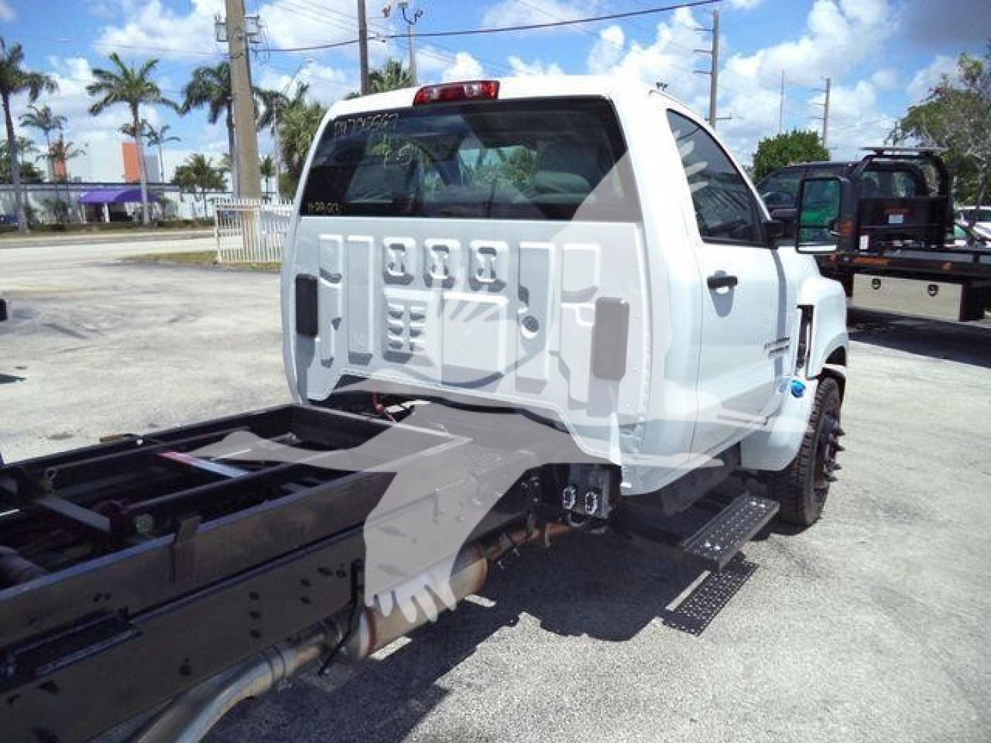 Truck rear and chassis showing Silverado 6500HD with dump bed; visible text includes 'CHEVROLET' on tailgate and general vehicle silhouette; no VIN or numbers clearly legible.
