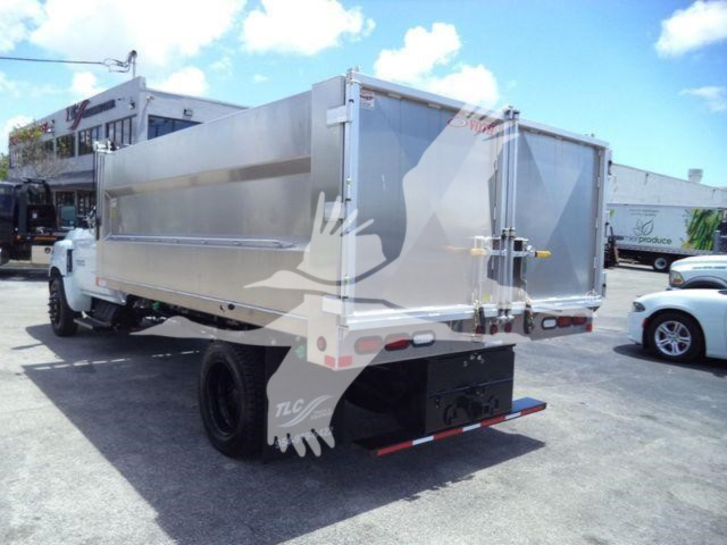 Dump truck bed of a 2023 Chevrolet Silverado 6500HD with aluminum dump body, rear view showing tailgate and rear bumper.