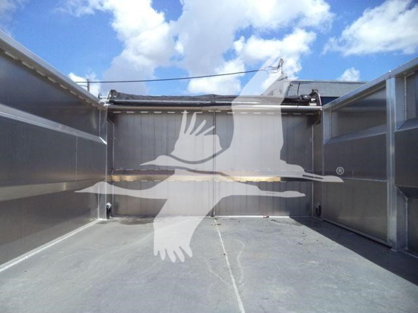 Chevrolet Silverado 6500HD dump truck bed interior showing metallic sidewalls and hydraulic dump system at the rear.