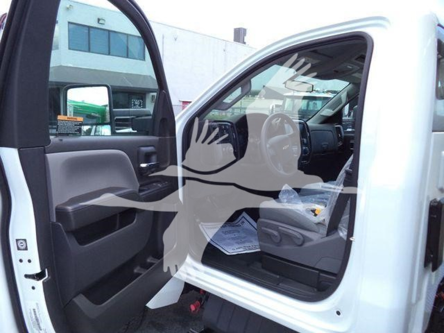 Open Silverado 6500HD dump truck cab interior view with door open and steering wheel visible.
