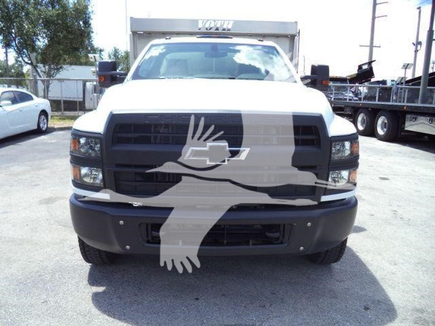 Chevrolet Silverado 6500HD chassis truck front view with black grille and large bumper.
