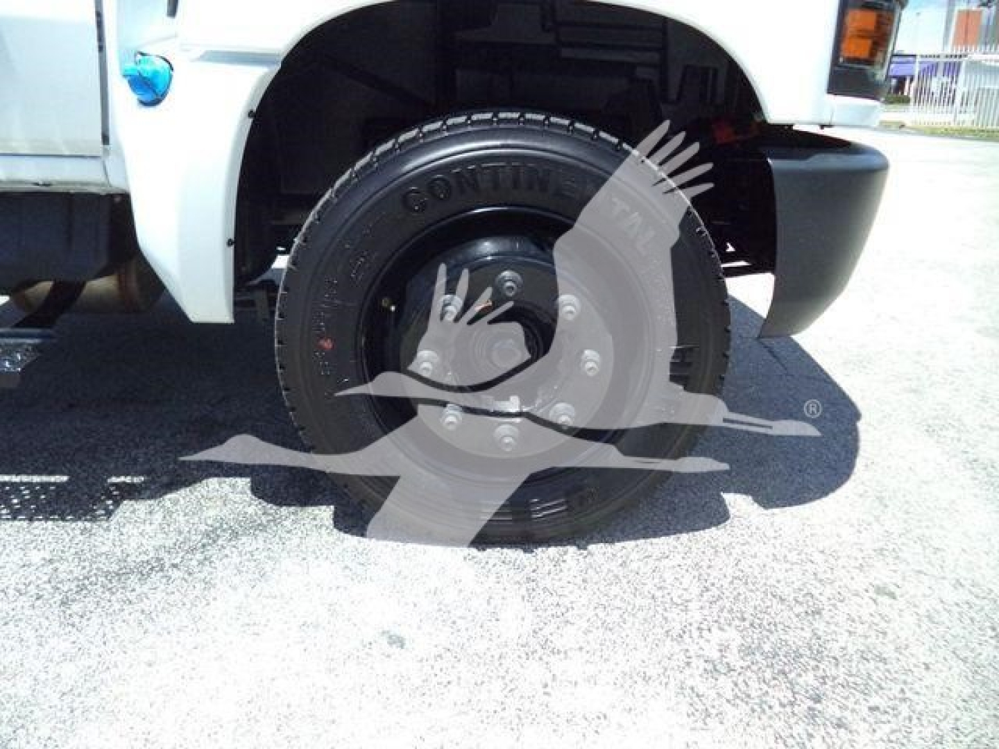 Front left wheel and tire of a 2023 Chevrolet Silverado 6500HD dump truck showing Continental tire and wheel assembly.