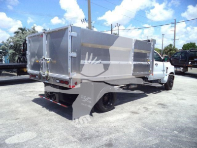 Dump truck bed of a 2023 Chevrolet Silverado 6500HD with aluminum dump body and dual rear wheels, side view.