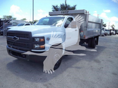 Chevrolet Silverado 6500HD dump truck front-left view showing aluminum dump body and lettering, in service yard.