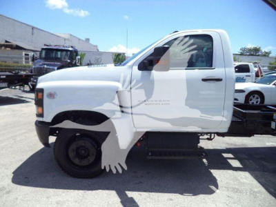 Chevrolet Silverado 6500HD dump truck cab side view with white body and black front fender, single cab, no bed, stock number 6500ALUMDMP visible in listing