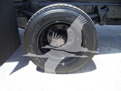 Truck wheel and tire on Silverado 6500HD dump truck showing heavy-duty Hankook or Michelin-style tire with wheel rim and undercarriage.