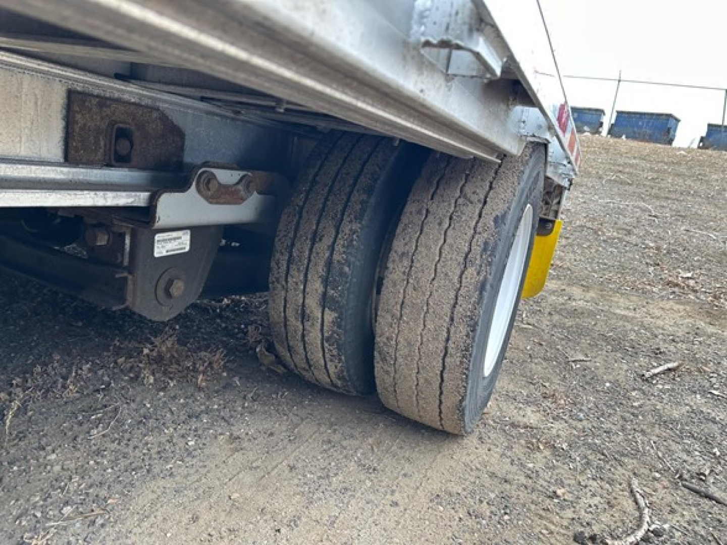 Trailer wheel and undercarriage view of a 2016 Trail King Tk all aluminum air ride drop deck showing dual tires and suspension components