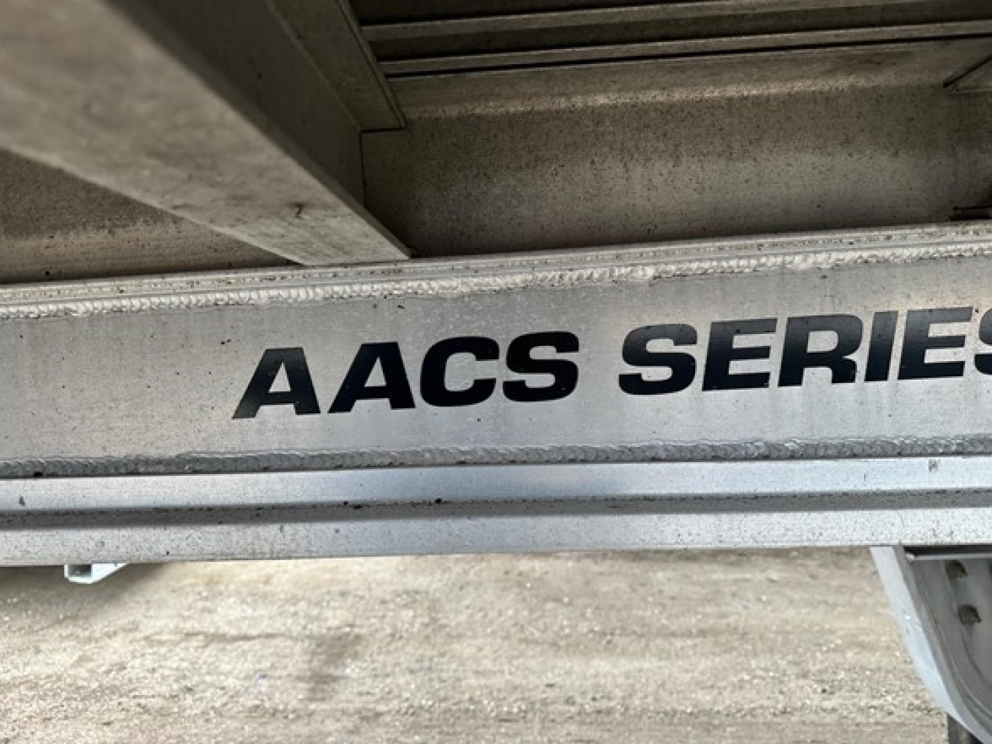 Trail King Tk all aluminum air ride drop deck trailer with AACS SERIES marking on side rail.