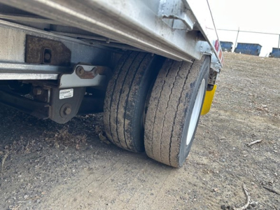 Trailer wheel and undercarriage view of a 2016 Trail King Tk all aluminum air ride drop deck showing dual tires and suspension components