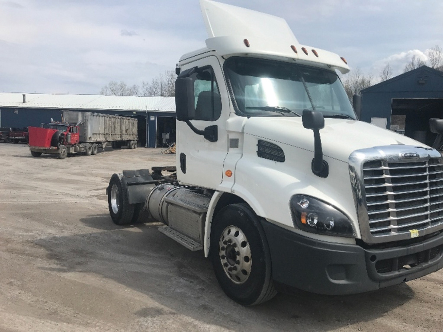 Truck cab shown with white Freightliner Cascadia113 chassis and front grille, side mirrors, and sleeper cab from a used listing.