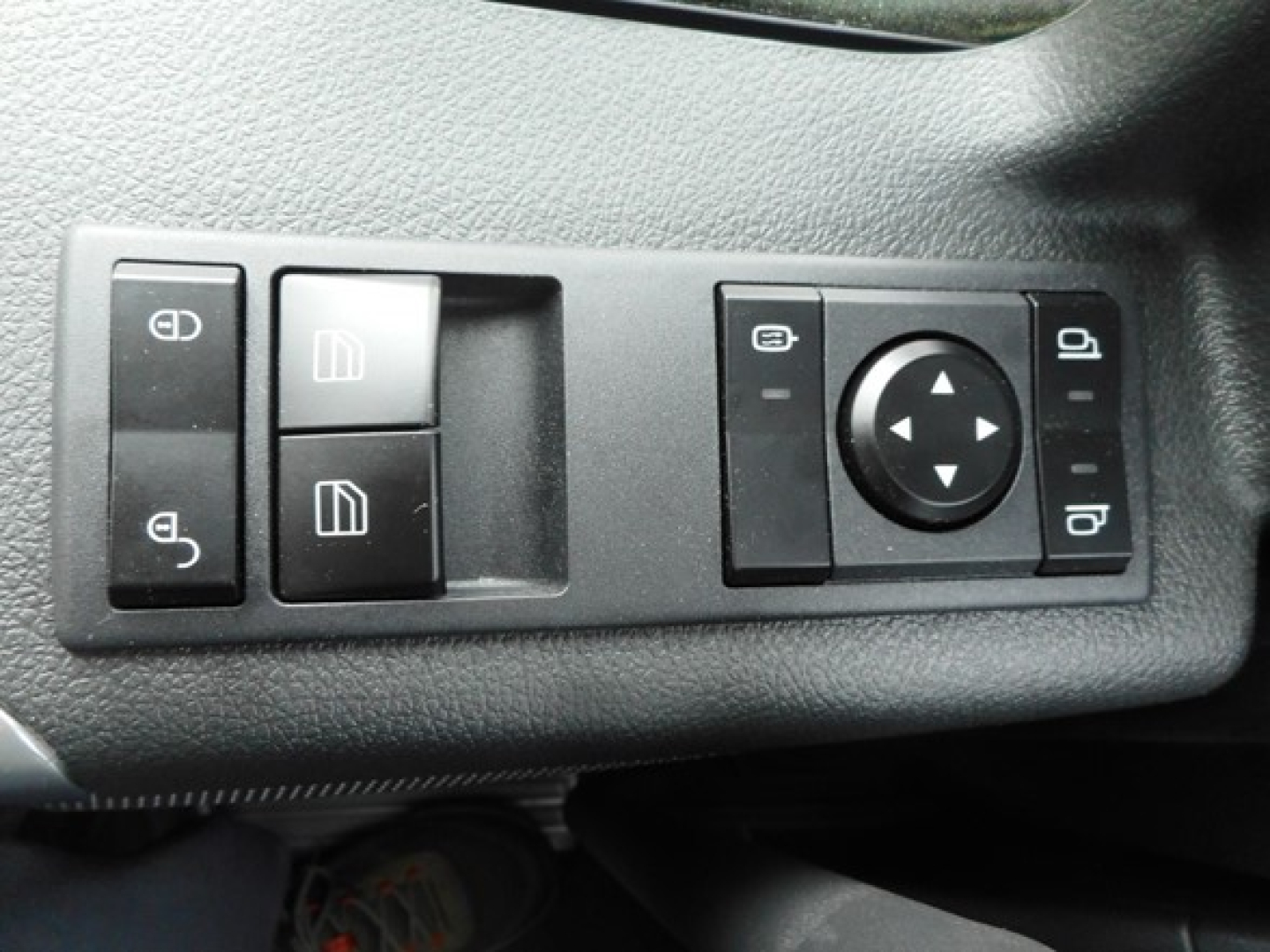 Dashboard controls showing window lock switches and mirror adjustment knob in a Western Star 49X cab, left and right rocker switches visible.