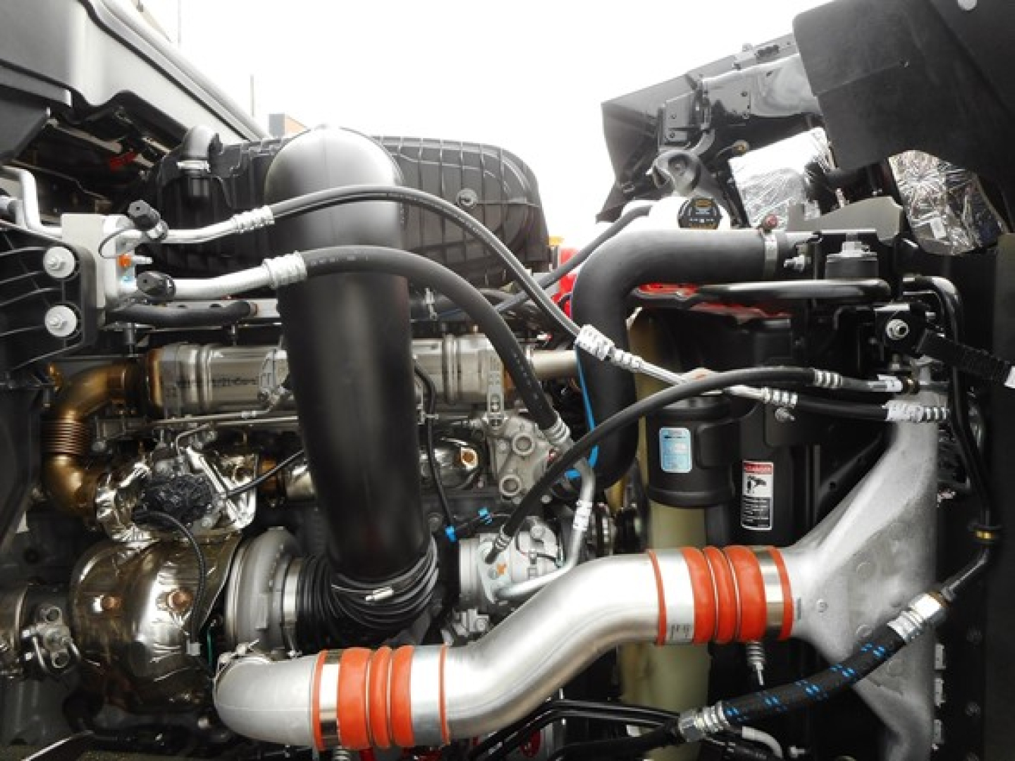 Western Star 49X engine bay showing intake tubing, hoses, and turbocharger components.