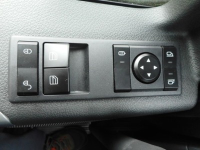 Dashboard controls showing window lock switches and mirror adjustment knob in a Western Star 49X cab, left and right rocker switches visible.