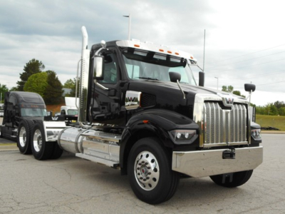 Western Star 49X day cab truck in black with chrome grille and dual exhaust stacks, front view, chrome bumper, chrome fuel tanks.
