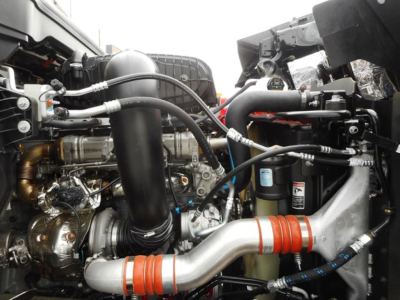 Western Star 49X engine bay showing intake tubing, hoses, and turbocharger components.