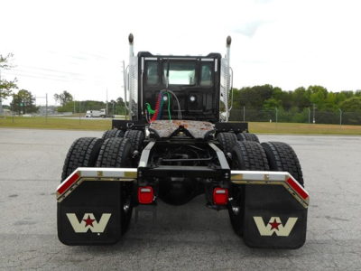 Western Star 49X rear view showing dual rear axles, fifth wheel, and mudflaps with Western Star logo.
