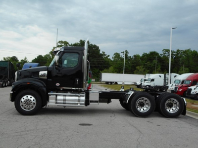 Western Star 49X truck side view with black cab and chrome fuel tanks, heavy-duty chassis, 6x4 configuration, no visible trailer.