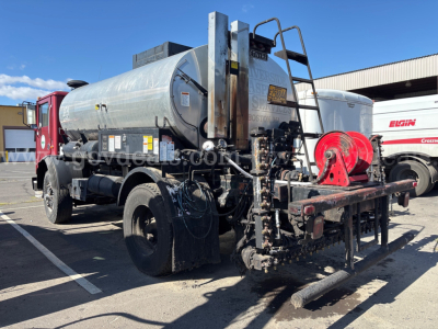 Tank truck rear and side showing hose reels and ramp apparatus with metal tank and red winch