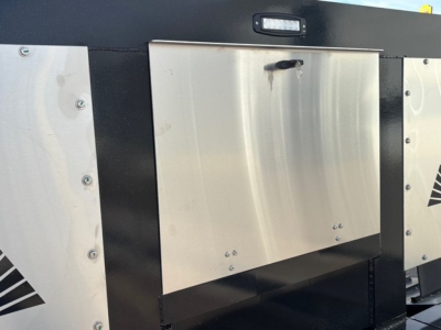 Alpha A80MG lowboy trailer side panel with stainless steel toolbox and hinge area, showing metal plate and black painted frame.